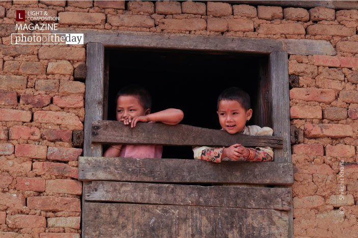 Siblings in the Window, by Shikchit Khanal Siblings in the Window, by Shikchit Khanal - Candid Photography, Award Winning Photography, Photojournalism, Photography Education, Art Photography