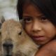 Peruvian Girl and Friend, by Claudio Bacinello Peruvian Girl and Friend, by Claudio Bacinello - Photojournalism, Photography Awards, Portrait Photography, Documentary Photography, Capybara