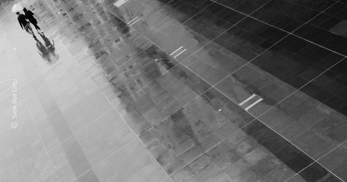 Sharing an Umbrella, by Siew Bee Lim - Minimalist Photography, Photo of the Day, Photography Awards, Online Photography Courses, Art Photography
