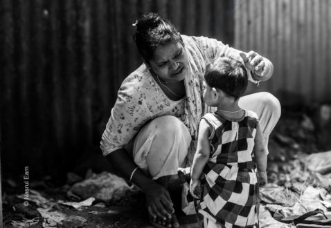 A Mother Adjusting Her Daughter’s Hair