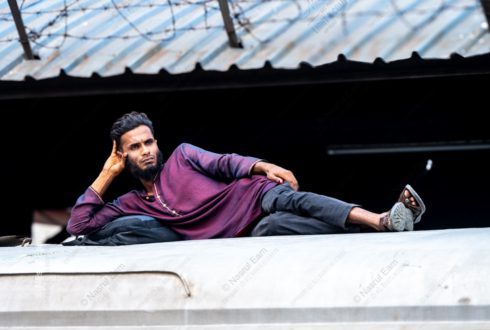 Traveler Resting Atop a Train Carriage