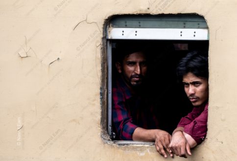 Two Men Looking Out from a Train Window
