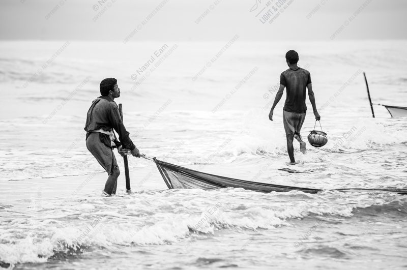 Two Fishermen in the Coastal Surf Two Fishermen in the Coastal Surf - Fine Art Photography Print, Limited Edition Print, Black and White Photography, Art Photography, Photography for Collectors