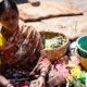 A Market Vendor Amidst Her Flowers and Coconuts A Market Vendor Amidst Her Flowers and Coconuts - Fine Art Photography Print, Limited Edition Print, Giclée Print, Photography Art, Documentary Photography