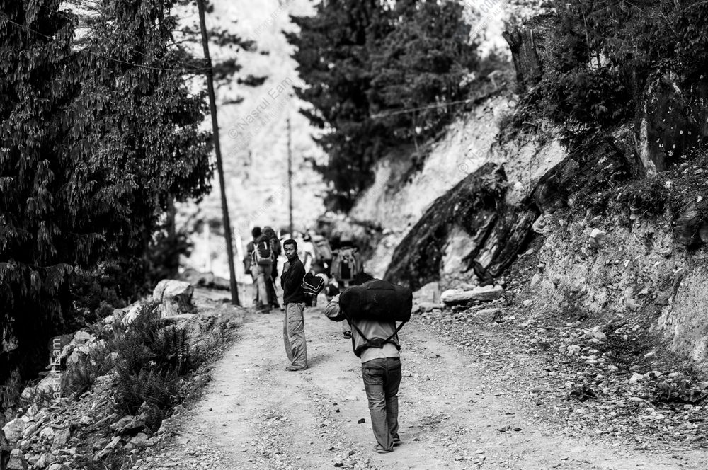 Porters on a Winding Mountain Trail