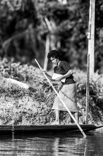 Woman with a Book, Poling a Canoe Woman with a Book, Poling a Canoe - Fine Art Photography Print, Limited Edition Print, Black and White Photography, Giclée Print, Documentary Photography