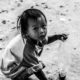 A Child Crouching in the Dust A Child Crouching in the Dust - Fine Art Photography Print, Limited Edition Photography, Black and White Portrait, Giclée Print, Child Portrait