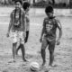 Boys with a Soccer Ball on a Worn Field - Fine Art Photography Print, Limited Edition Photography, Monochrome Photography, Childhood Photography, Art Photography for Sale