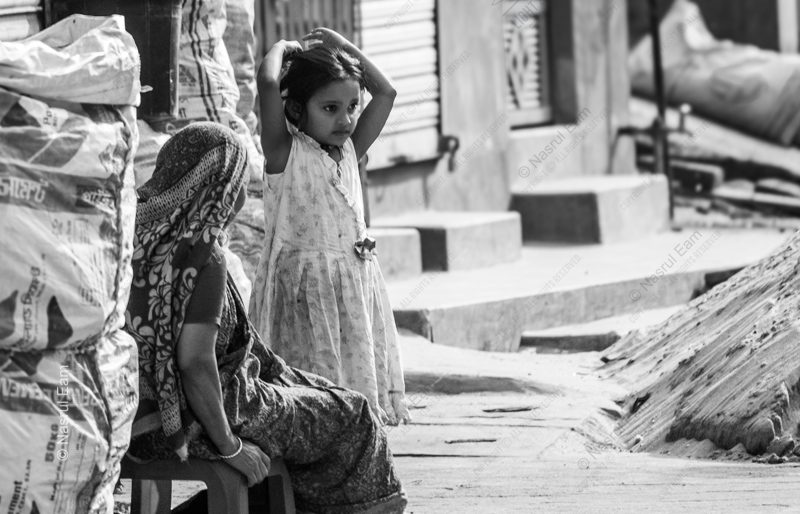 A Girl and a Woman by the Sacks A Girl and a Woman by the Sacks - Fine Art Photography Print, Limited Edition Photography, Black and White Photography, Giclée Print,  Human Emotion Photography