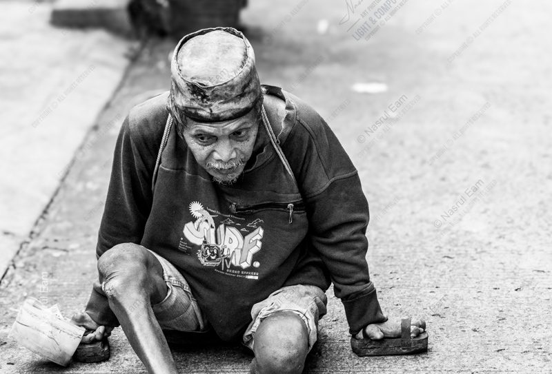 Man with Wooden Blocks on the Pavement