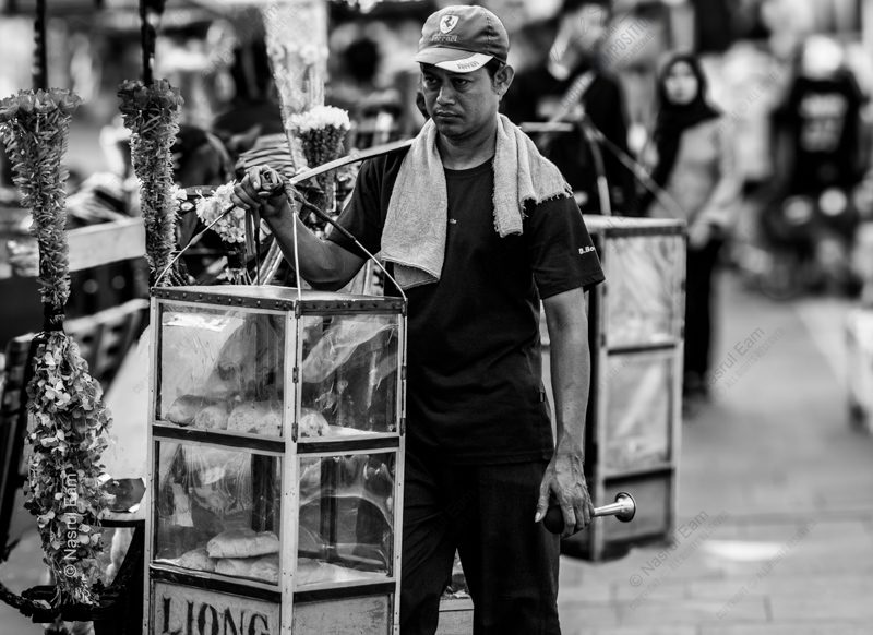The Vendor with the Glass Case The Vendor with the Glass Case - Fine Art Photography Print, Limited Edition Photography, Contemporary Art Photography, Documentary Photography, Black and White Photography