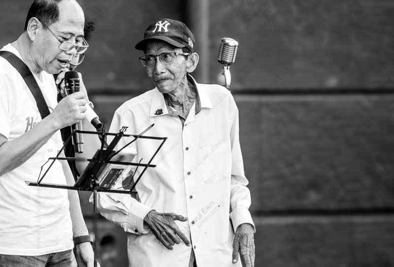 An Elder Listening Beside the Singer An Elder Listening Beside the Singer - Fine Art Photography Prints, Limited Edition Photography, Museum-Quality Photography, High-End Photography Prints, Art Photography Collectors
