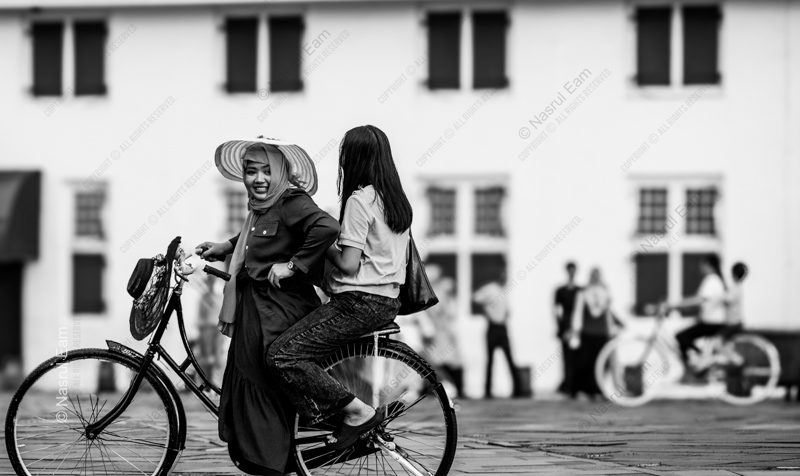 Women on a Bicycle in the Town Square Nasrul Eam