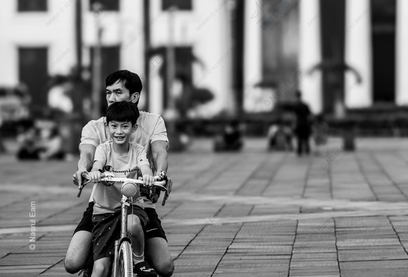 Father and Son Riding in the Plaza Nasrul Eam