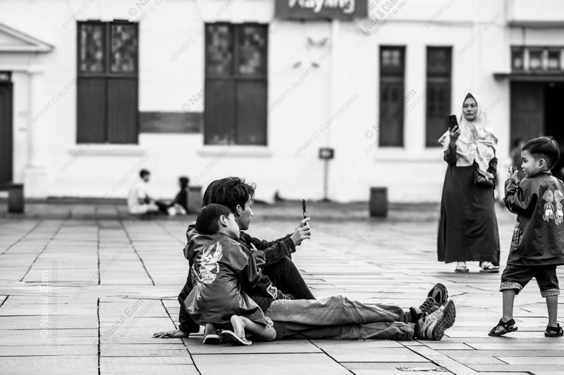 A Father and Child Seated in the Plaza A Father and Child Seated in the Plaza