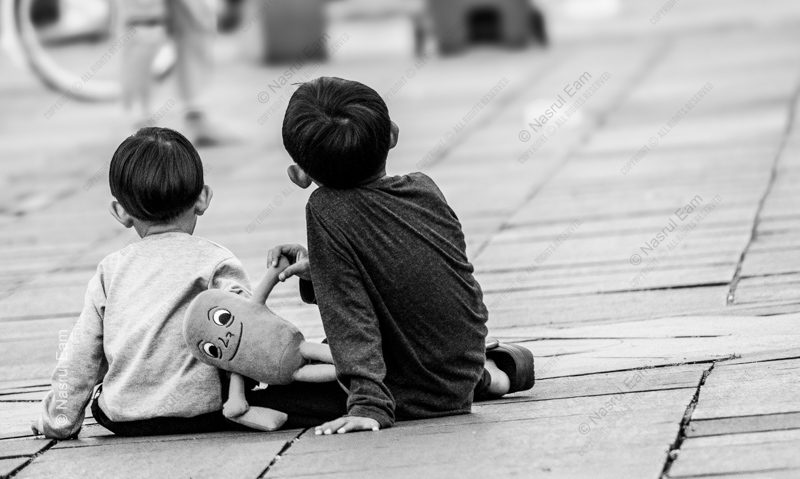 Two Boys on a Wooden Walkway Two Boys on a Wooden Walkway