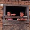 Siblings in the Window, by Shikchit Khanal - Candid Photography, Award Winning Photography, Photojournalism, Photography Education, Art Photography