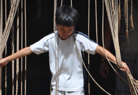 Playing with the Door Drapes, by Ryszard Wierzbicki - Candid Photography, Photojournalism, Photography Awards, Photo of the Day, Ryszard Wierzbicki