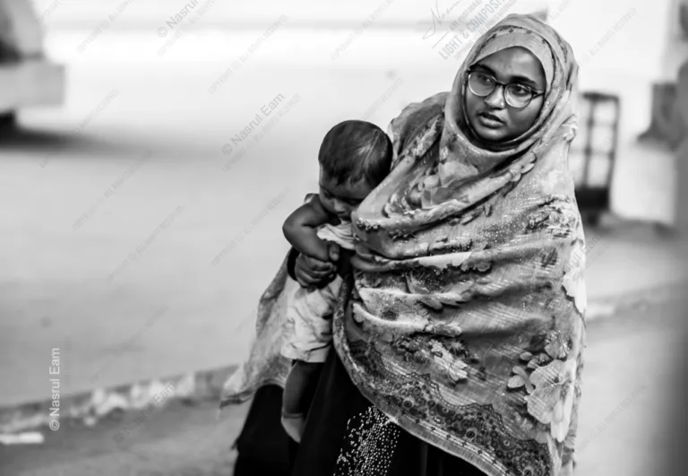 A Mother Carrying Her Child