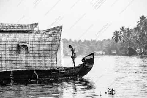 Solitary Figure on the Houseboat Bow