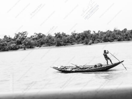 Man and Oar on Flowing Water