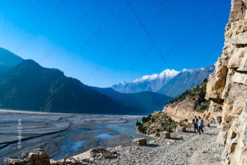 Mountain Pass with Riverbed and Travelers