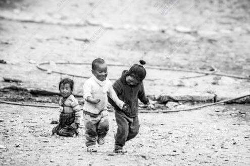 Three Figures in Motion on Dusty Ground