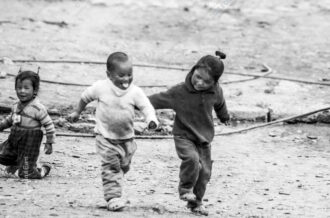 Three Children Running Across the Stony Path - Three Children Running Across the Stony Path, Three Children Running Across the Stony Path print, Nasrul Eam fine art print, limited edition prints, monochrome lifestyle photography, fine art photography