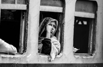 Patterned Scarf and Bangle at the Train Window - Patterned Scarf and Bangle at the Train Window, Nasrul Eam fine art print, train window art print, candid fine art photography, monochrome candid portrait, limited edition print