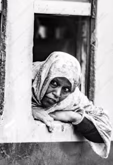 Woman in Patterned Headscarf Leaning Outward