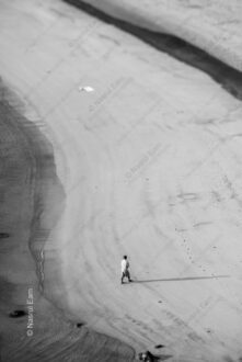 Figure on Sandy Expanse, Long Shadow