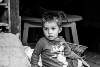 Young Face in Shadowed Hearth - Young Face in Shadowed Hearth, Nasrul Eam portrait, black and white child portrait, limited edition fine art print, chiaroscuro photography, conceptual portraiture