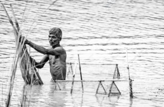 Man and His Nets in Rippling Water - Man and His Nets in Rippling Water, Nasrul Eam fine art print, limited edition photography, monochrome art print, documentary photography for sale, fishing nets art photo