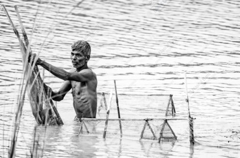 Man and His Nets in Rippling Water