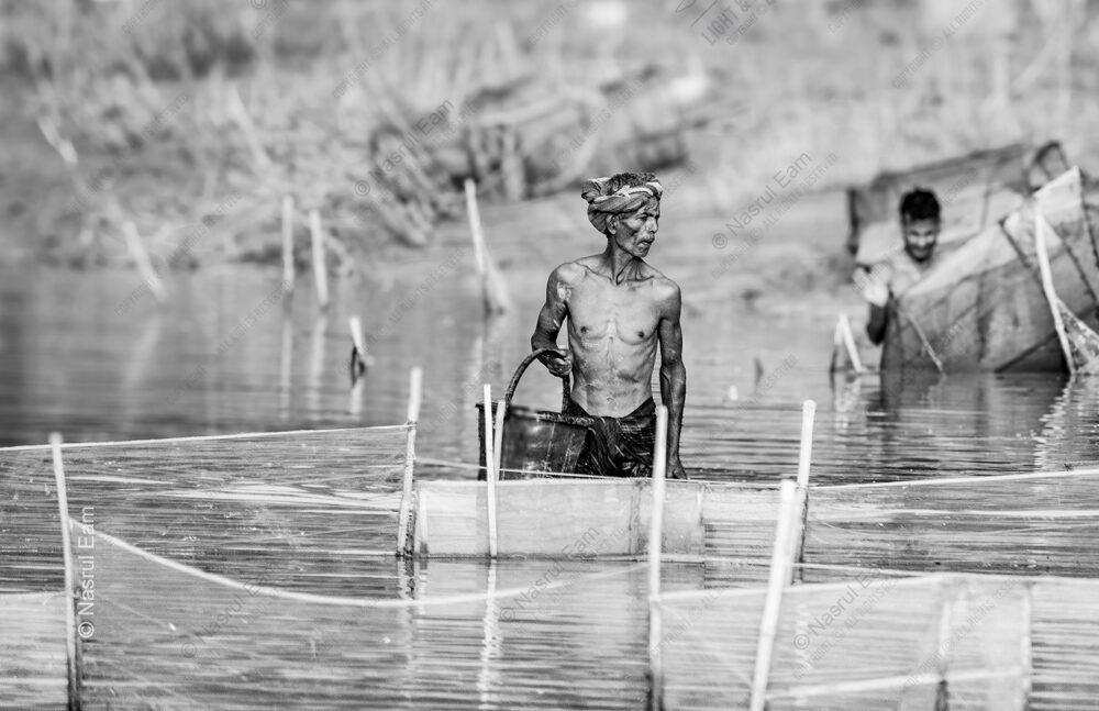 Man Navigating Water Nets - man navigating water nets, Nasrul Eam photography, monochrome fine art print, limited edition prints, documentary photography art, visual storytelling photography