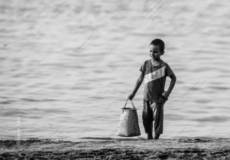 Boy with Woven Basket at Water's Edge