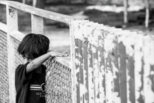 Child's Hand on Weathered Rail