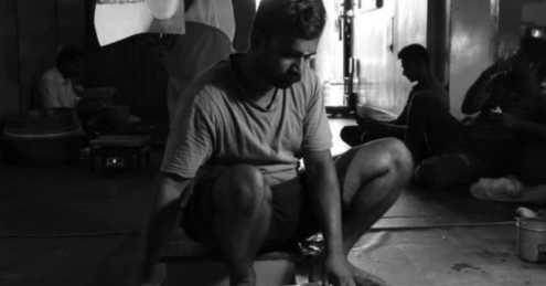 The Man Talking with Newspaper by Karthick Saravanan - Photojournalism, Documentary Photography, Black and White Photography, Photography Awards, Light & Composition University