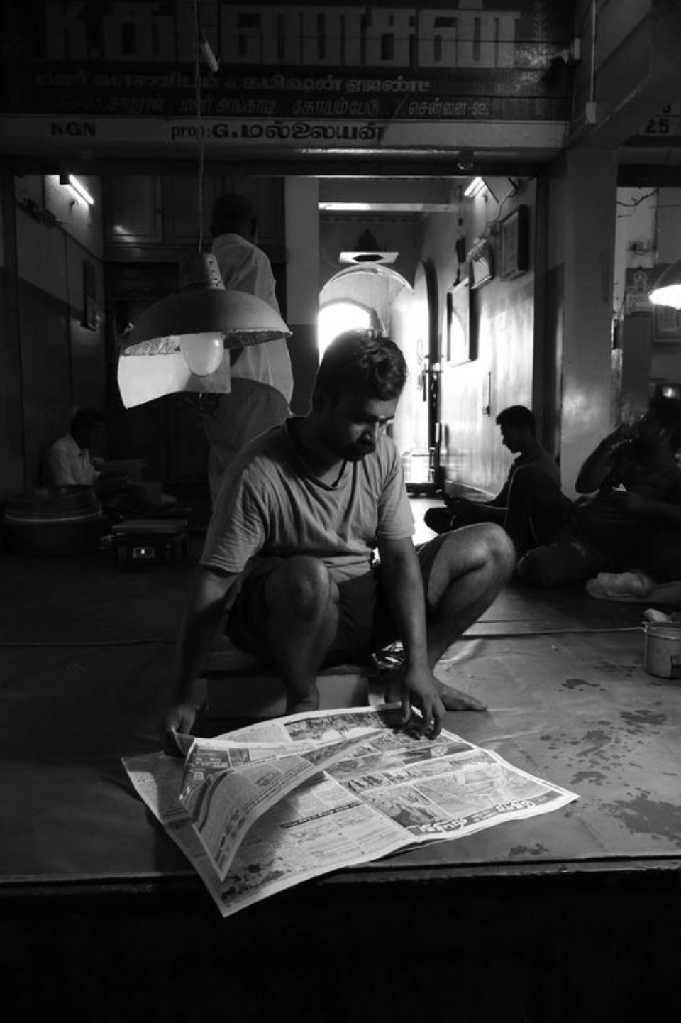 The Man Talking with Newspaper by Karthick Saravanan
