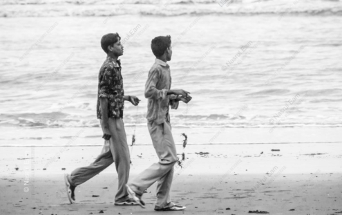 Boys Carrying Crabs Along the Shore