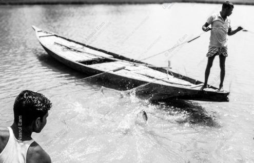 Two Fishermen Hauling the Net