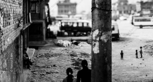 Figures in a Divided Alleyway - street photography, documentary photography, visual storytelling, photography composition, urban photography, black and white photography