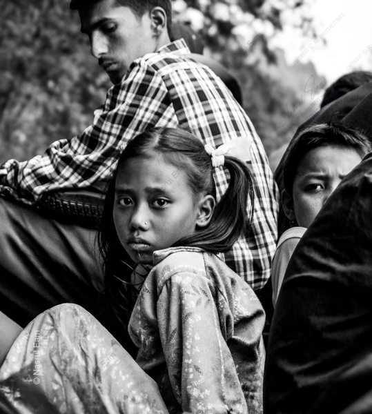 A Young Girl's Gaze Amidst the Crowd