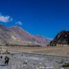 Porters on the Stone Riverbed - Photography, Visual Storytelling, Human Endurance, Fine Art Photography, Documentary Photography, Landscape Photography