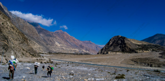 Porters on the Stone Riverbed - Photography, Visual Storytelling, Human Endurance, Fine Art Photography, Documentary Photography, Landscape Photography