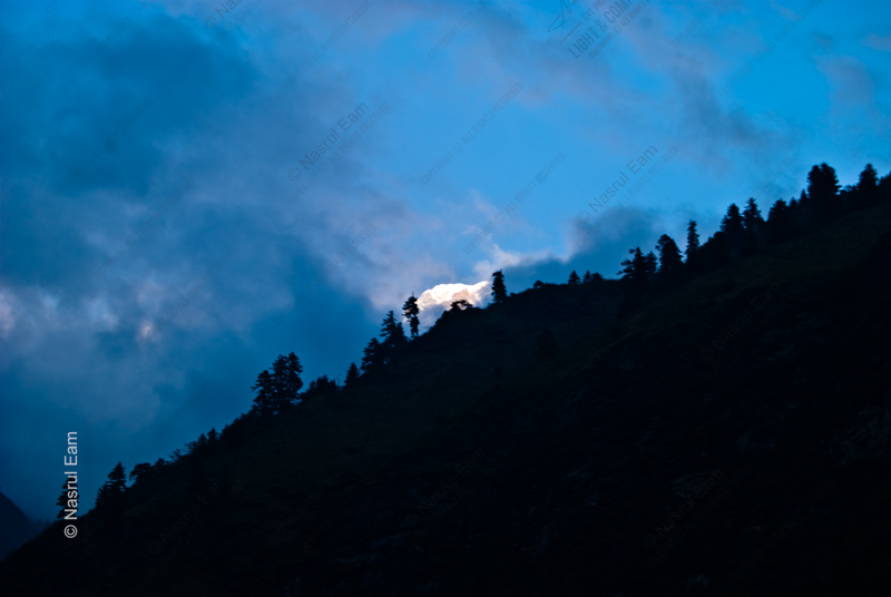 Light Behind the Forested Ridge