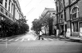 Two Men Crossing a Rain-Washed Street