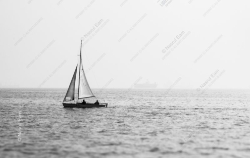Sailboat on a Hazy Sea