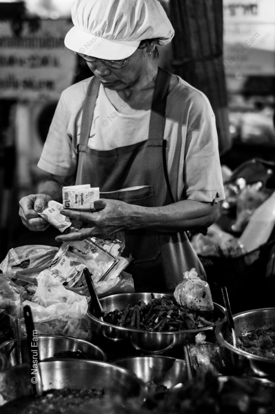 The Vendor Counting Her Earnings