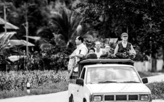 Travelers on a Road Through the Village